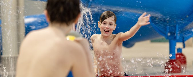 Zwei Jungs spielen mit Wasserkanonen auf dem Wasserspielplatz